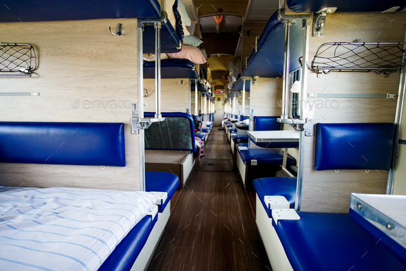 Interior of a typical russian long-distance RZD train with beds for  sleeping Stock Photo by EwaStudio